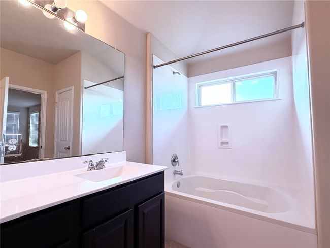 Bathroom featuring shower / washtub combination and vanity | Image 18