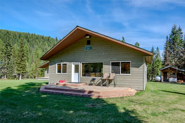 Back of property with a yard and a forest view | Image 83