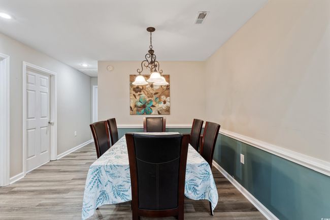Dining room featuring wood finished floors, recessed lighting, and a chandelier | Image 14