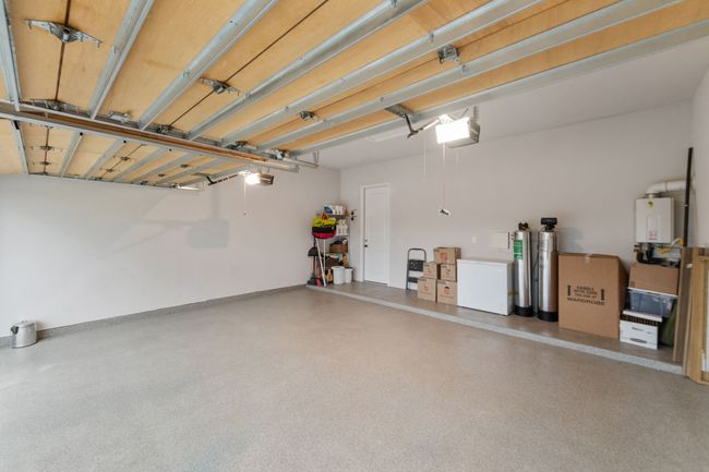 Spacious three-car garage with a custom lift system installed | Image 32