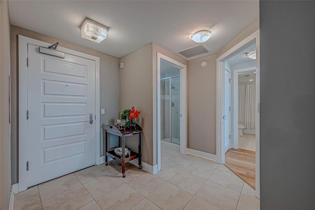 Welcoming entry with elegant custom tile and seamless bamboo flooring throughout. | Image 4