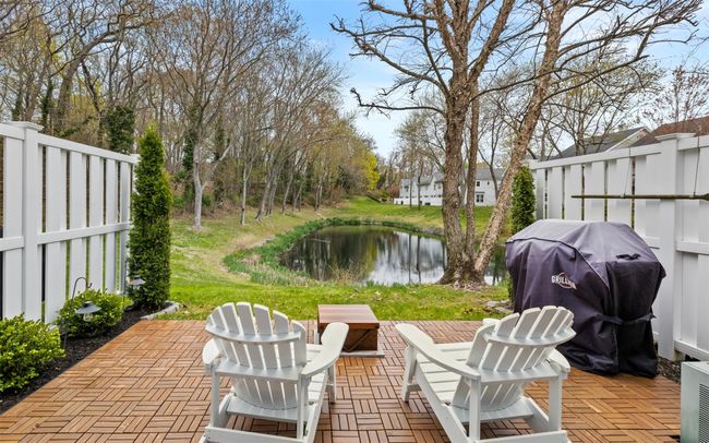 View of patio / terrace with area for grilling, a water view, and fence | Image 19