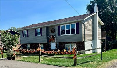 Raised ranch featuring a front yard | Image 1