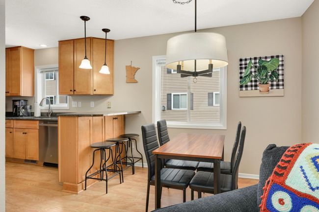 View of the breakfast bar and dining room table | Image 13
