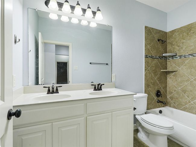 Full bathroom with double vanity and shower / tub combination | Image 32