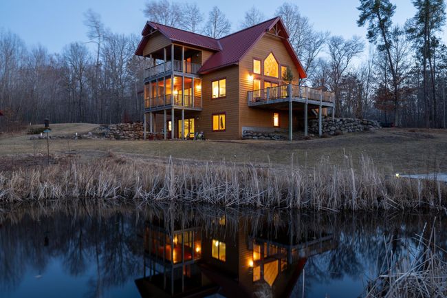 This beautiful twilight photo highlights the many windows in this home. | Image 6