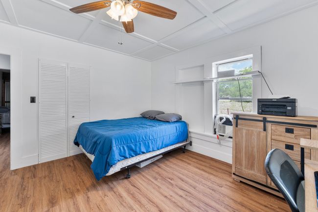 Bedroom with wood finished floors, ceiling fan, and coffered ceiling | Image 11