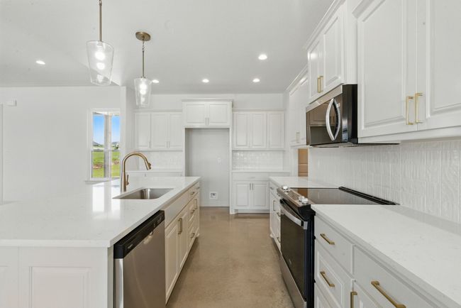 Kitchen with stainless steel appliances, a sink, finished concrete floors, tasteful backsplash, and recessed lighting | Image 7
