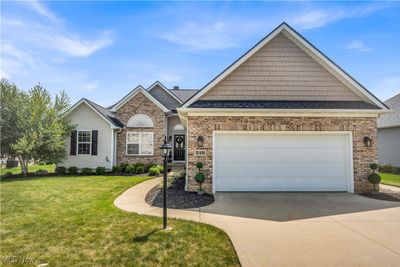 View of front of home featuring a garage and a front lawn | Image 1