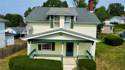 Front of home featuring a porch and a front yard | Image 1