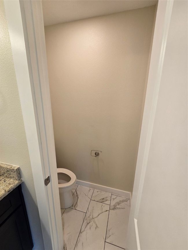 Bathroom featuring marble finish floors, vanity, toilet, and baseboards | Image 25