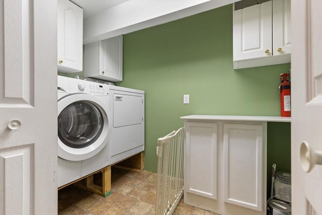Main floor laundry room just inside the attached garage entrway | Image 25