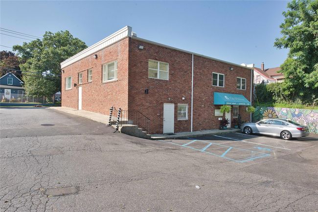View of building exterior featuring uncovered parking | Image 12