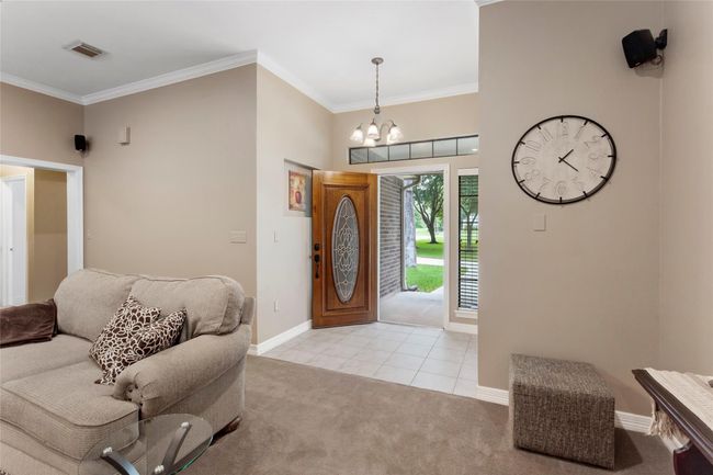 Family room looking back to the solid wood front door. Surround sound stays with the home. | Image 10