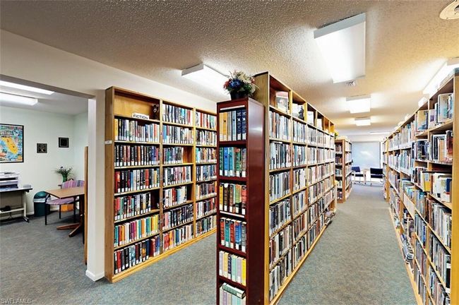 Miscellaneous room with bookshelves and carpet | Image 49