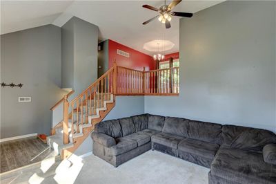 Living room featuring lofted ceiling, ceiling fan. | Image 3