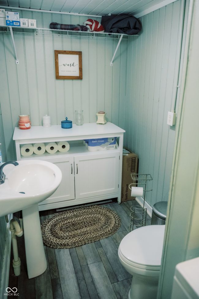 bathroom featuring toilet, wood finished floors, and wooden walls | Image 18