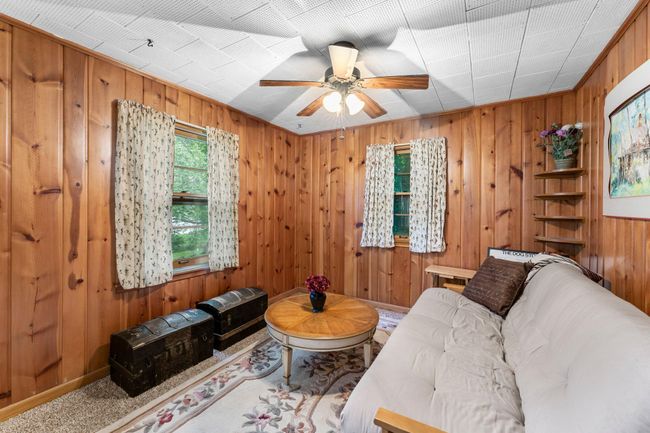 The family room includes carpeting and its own wood-burning fireplace for comfort and charm. | Image 20