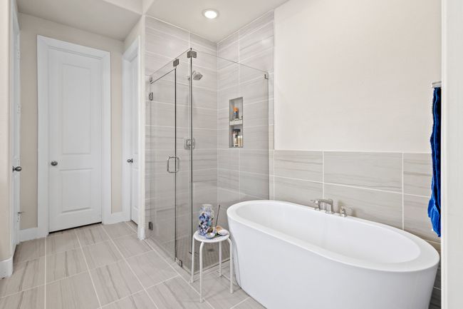 Bathroom with a shower stall, a freestanding tub, tile walls, and tile patterned​​‌​​​​‌​​‌‌​‌‌​​​‌‌​​‌‌​‌​​​​​‌ floors | Image 14