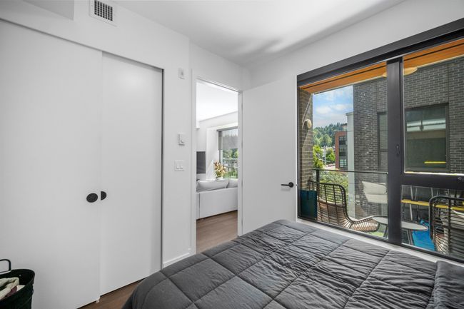 Bedroom featuring wood finished floors, access to outside, multiple windows, and a closet | Image 10