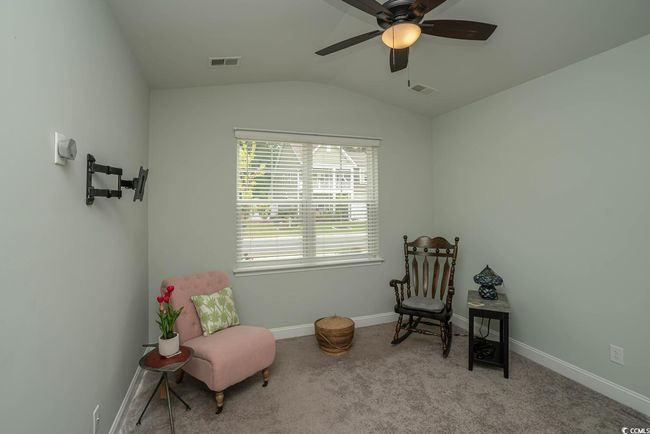 Living area with ceiling fan, lofted ceiling, carpet, and baseboards | Image 16