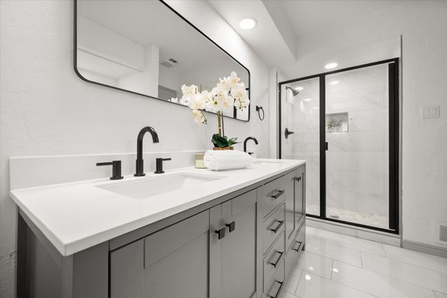 Primary en suite bathroom include dual sinks and separate stand-in shower. | Image 25