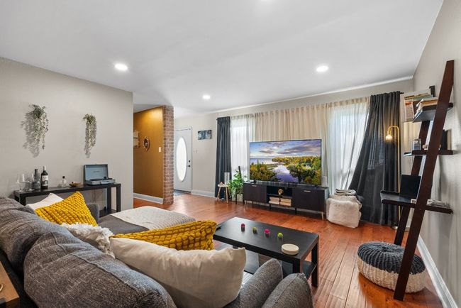 Living room with wood-style flooring, recessed lights and plenty of natural light | Image 4