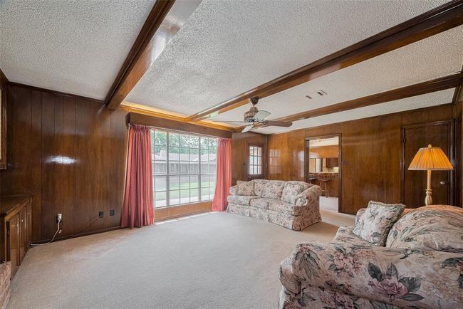 Bright and inviting family room with ample natural light. | Image 14