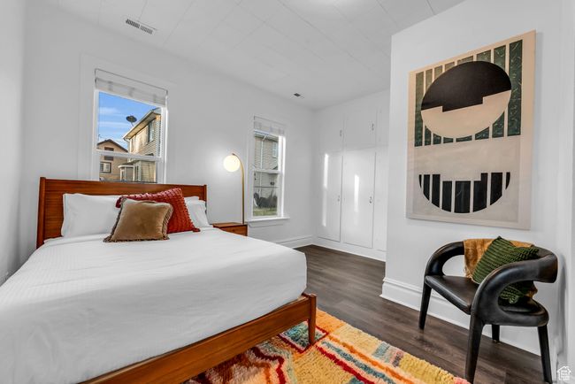Bedroom featuring dark wood-type flooring and baseboards | Image 8