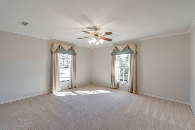 Bedroom #3 with windows on the front and side of the home. | Image 19