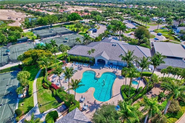 Aerial view of Colonial Club pool with an area for laps, the tennis courts and golf course that is been revamped! | Image 42