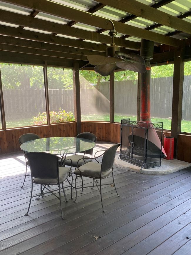 Sunroom / solarium featuring outdoor dining area | Image 15