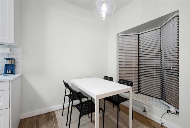 Dining space with wood finished floors and baseboards | Image 12