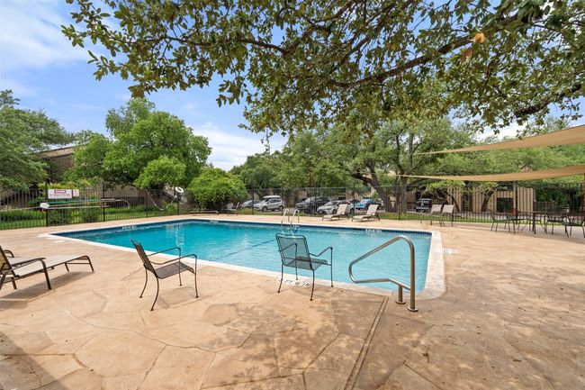 Community pool with fence and a patio | Image 29