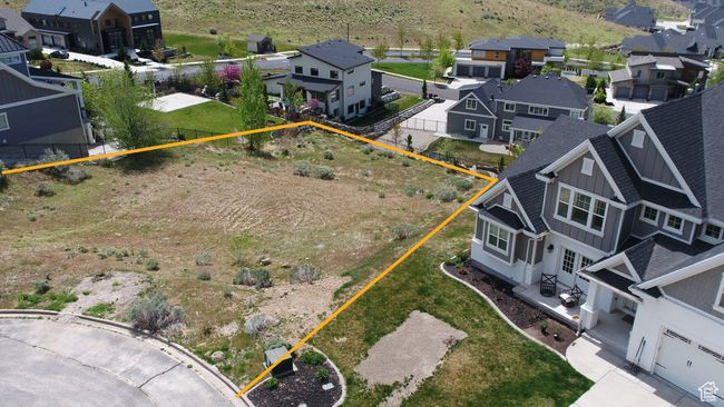 Aerial perspective of suburban area with property boundaries highlighted and mountains | Image 6