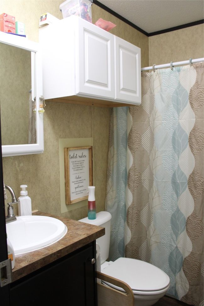 Full bath with toilet, vanity, crown molding, and curtained shower | Image 21