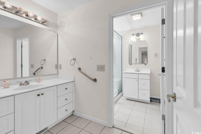 Bathroom with tile patterned flooring, vanity, and an enclosed shower | Image 12