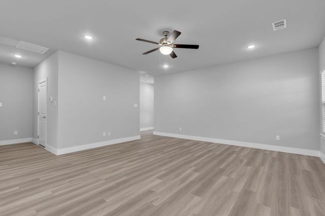 Unfurnished room featuring baseboards, visible vents, ceiling fan, and light wood-type flooring | Image 9
