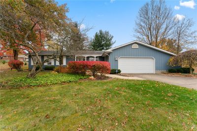 Single story home featuring a garage and a front lawn | Image 1