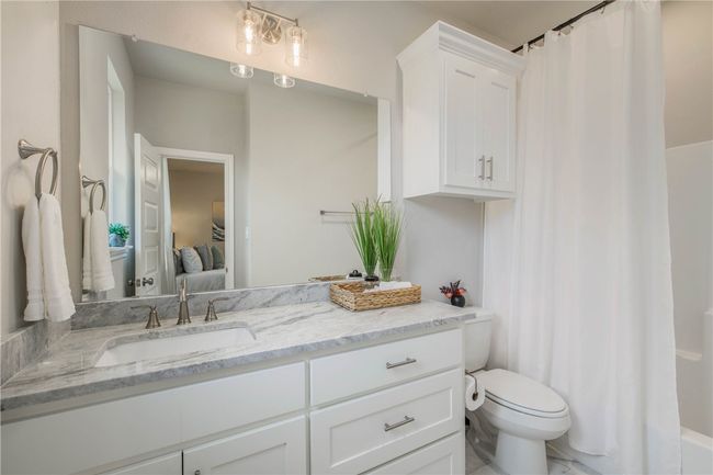 Ensuite bathroom featuring vanity and toilet | Image 21