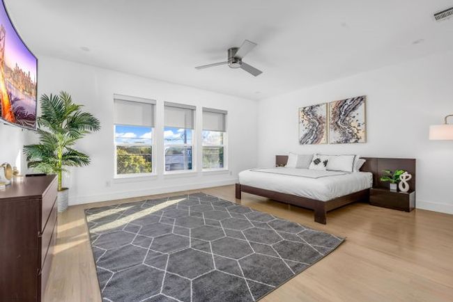Bedroom featuring ceiling fan and hardwood / wood-style flooring | Image 28