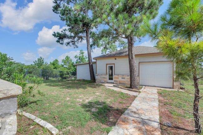 View of yard with concrete driveway and a garage | Image 37