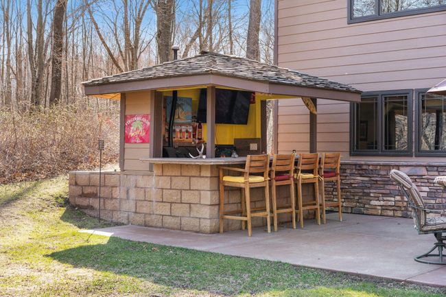 Belly up to the bar and tell your best fishing stories from your walk to the back of the property. | Image 35