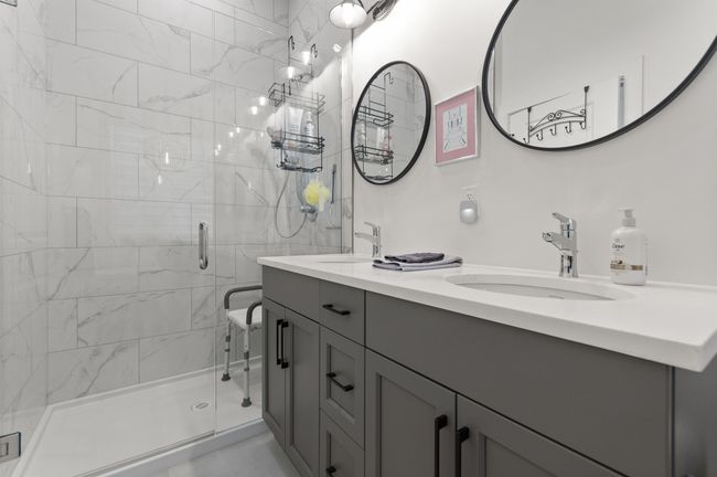 Bathroom with double vanity and a stall shower | Image 21