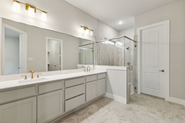 Full Primary bath with double vanity, a stall shower, and marble finish flooring | Image 18