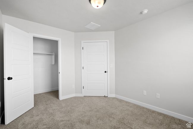 Unfurnished bedroom with carpet flooring and a closet | Image 30
