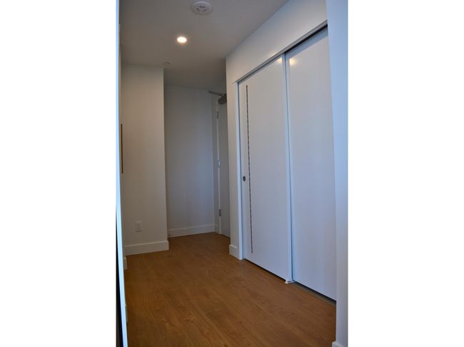 Hall featuring baseboards, wood finished floors, and recessed lighting | Image 8