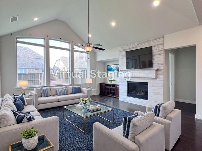 Living room with dark wood-style floors, vaulted ceiling, a fireplace, ceiling fan, and recessed lighting | Image 19