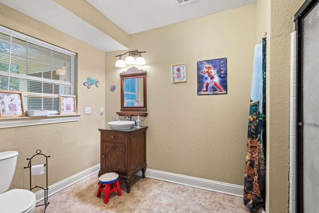 Full bath featuring an enclosed shower, toilet, vanity, visible vents, and baseboards | Image 29