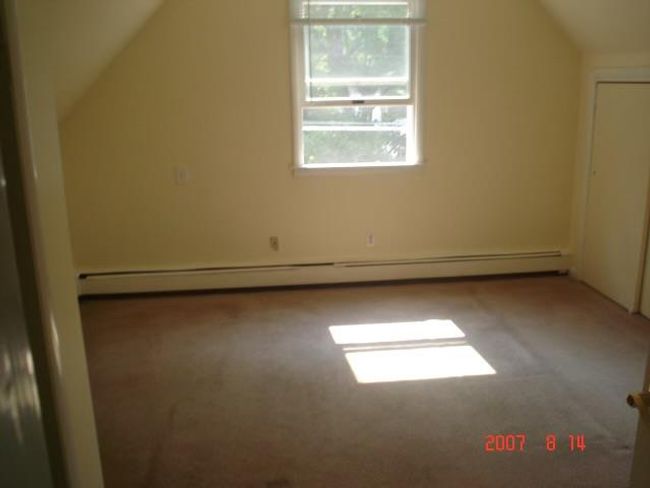 2nd Fl Bedroom with carpet flooring, vaulted ceiling, and a baseboard heating unit | Image 10